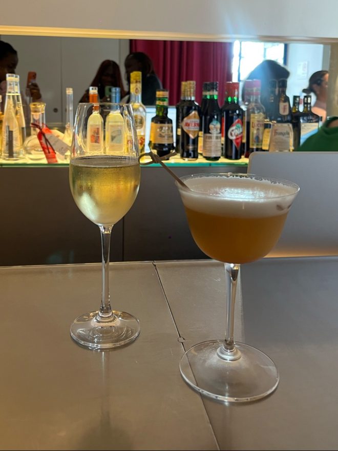 Drinks on the counter in front of the lit back bar