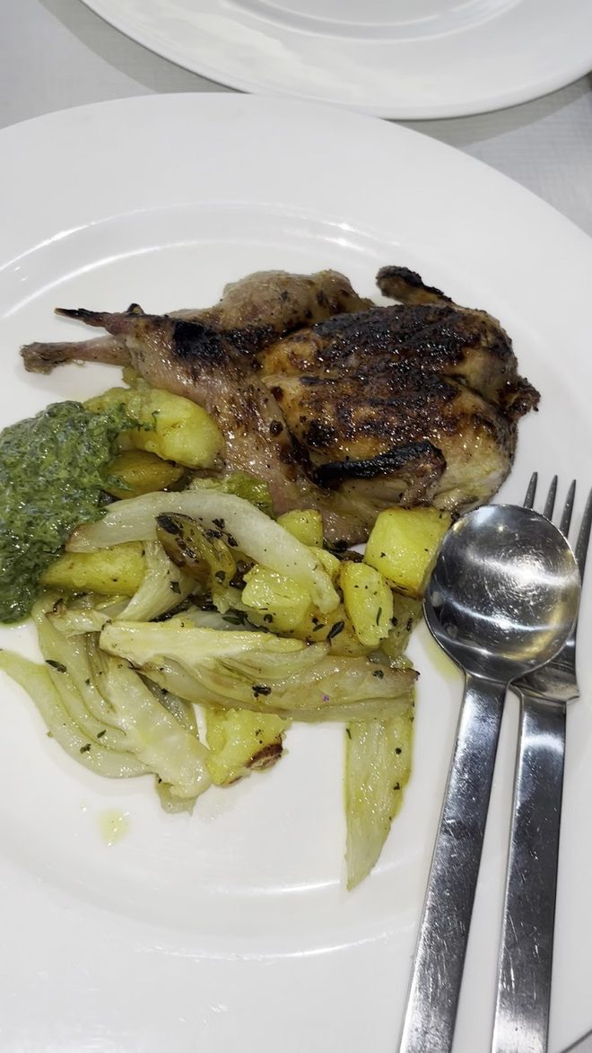 Grilled chicken with potatoes and greens, half eaten