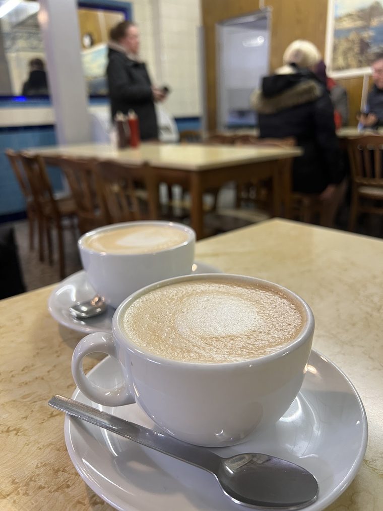 A cappuccino in a white cup on a marble table